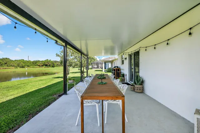 a front view of a house with a yard table and chairs