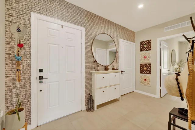 a room with a mirror and a dresser