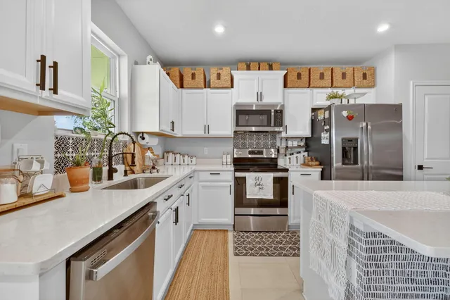 a kitchen with stainless steel appliances cabinets a sink and a counter top space
