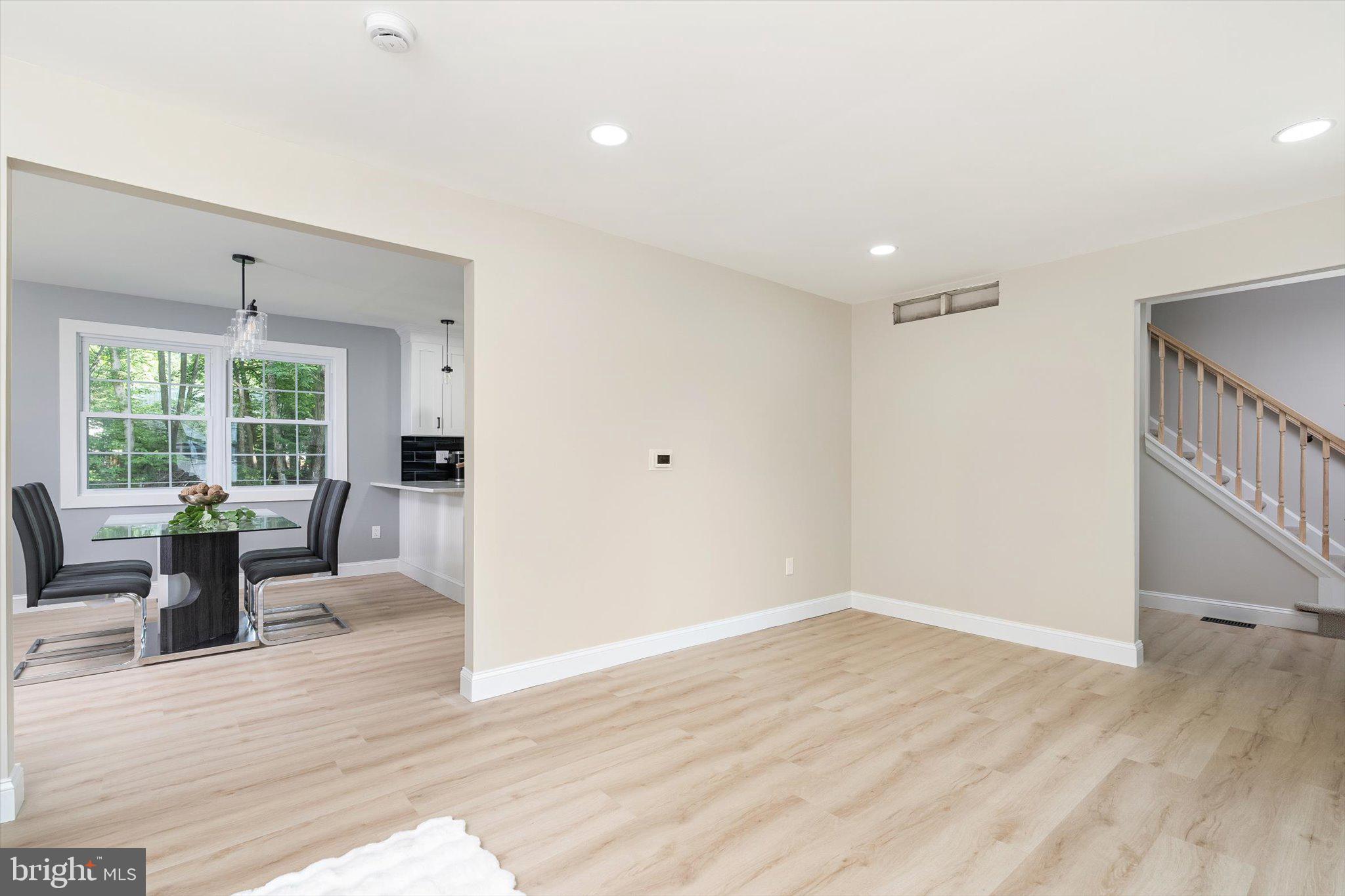 2 Tall Timber Lane Burlington, NJ 08016 - Photo 6 of 30 an empty room with wooden floor and windows