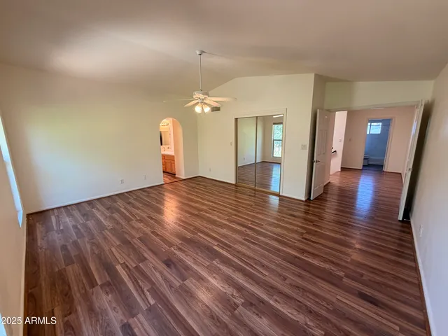 a view of a room with wooden floor