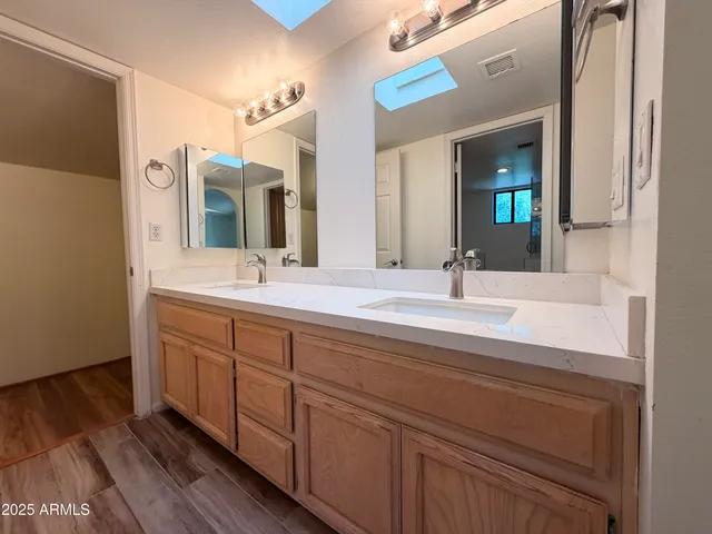 a bathroom with a double vanity sink and a mirror