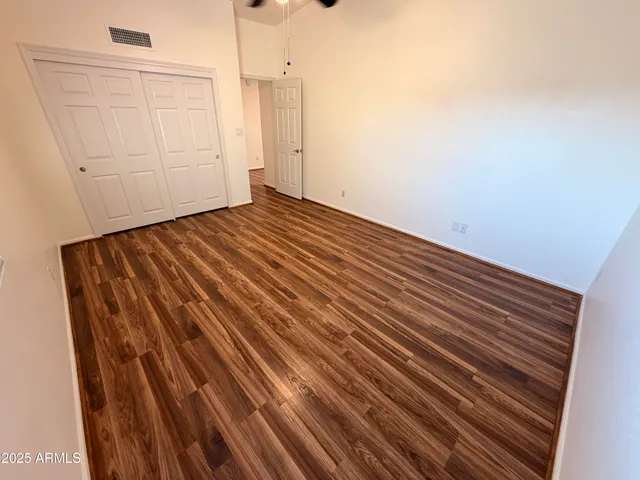 a view of a room with wooden floor