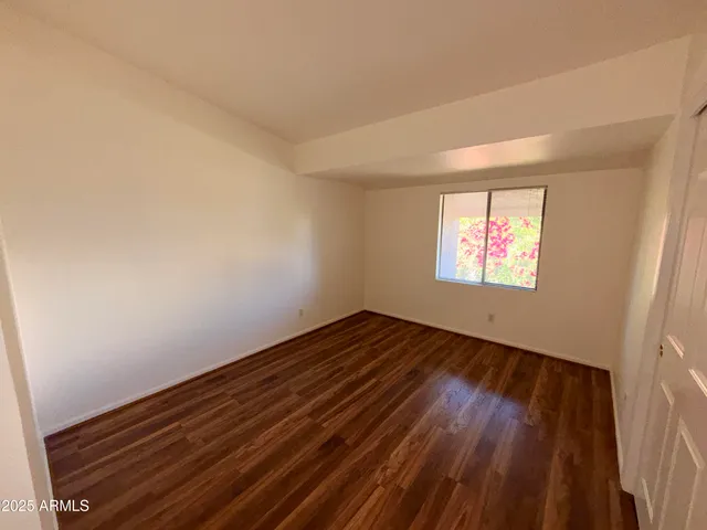 a view of an empty room and wooden floor