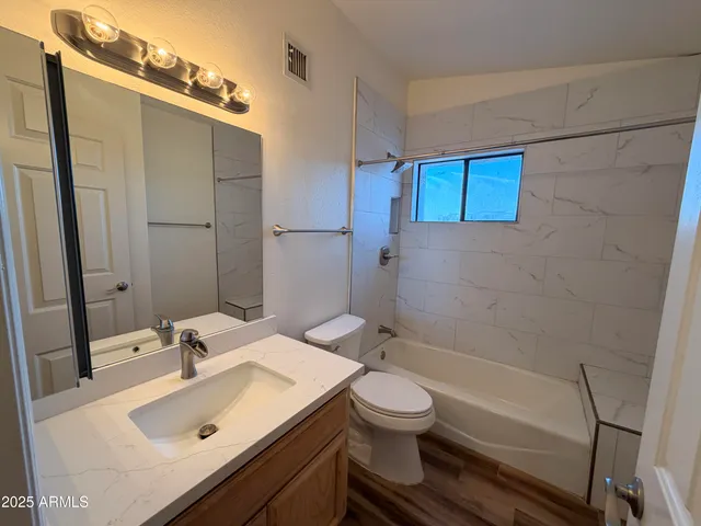 a bathroom with a sink toilet and shower
