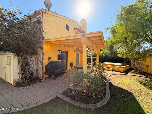 a view of a house with backyard and sitting area