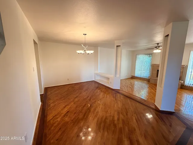 a view of a room with wooden floor