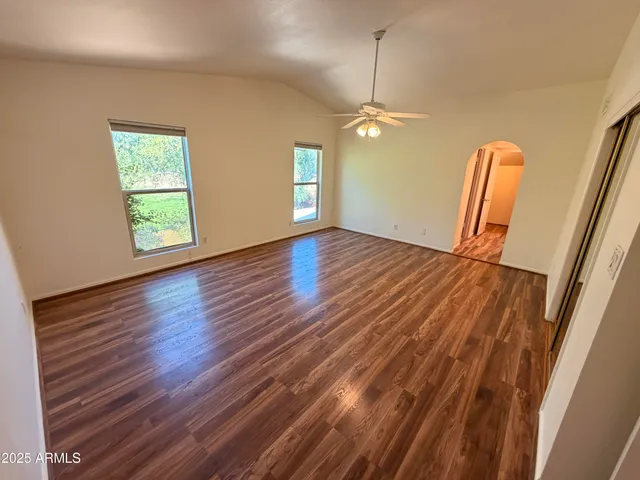 a view of room with wooden floor and window