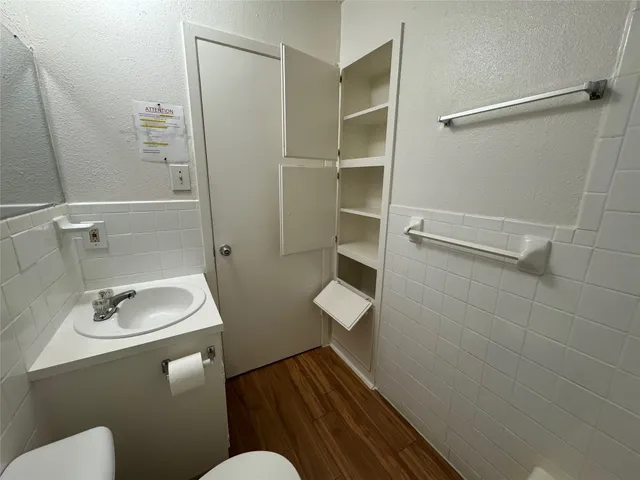 a bathroom with a sink toilet and shower