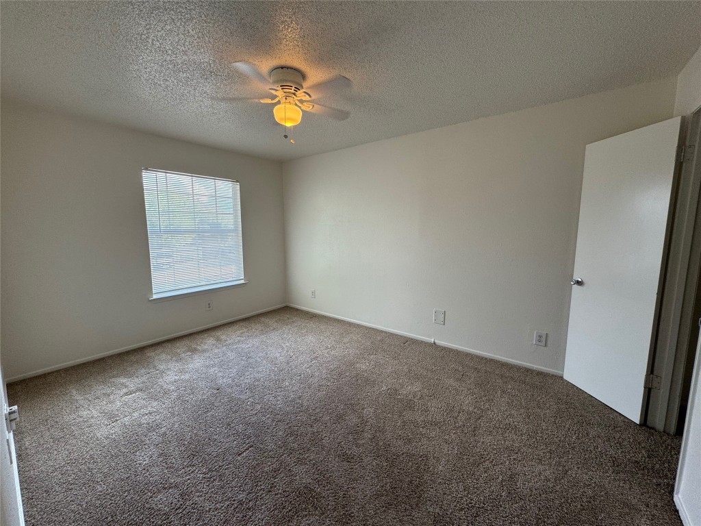 4810 West Wind Trail, Unit 101 Austin, TX 78745 - Photo 15 of 21 an empty room with windows and chandelier fan