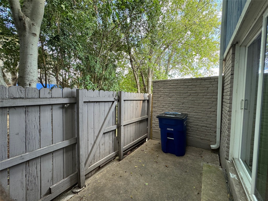 4810 West Wind Trail, Unit 101 Austin, TX 78745 - Photo 19 of 21 a view of a wooden house with a large window and wooden fence