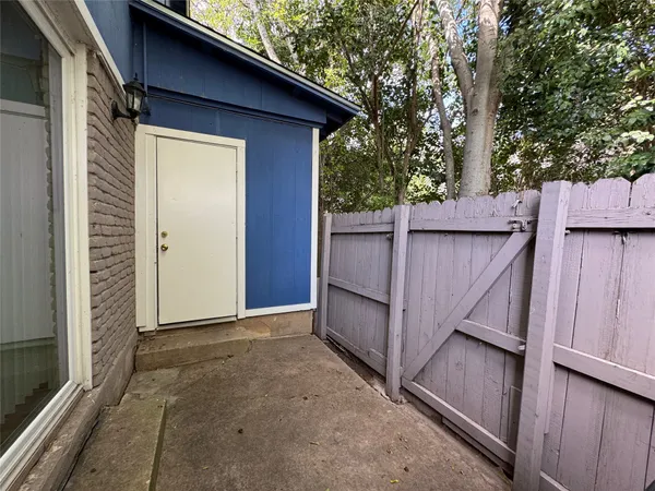 a view of a house with a wooden fence