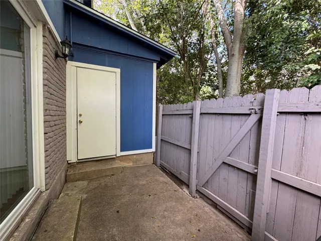 a view of a house with a wooden fence