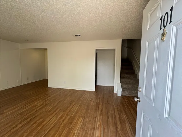 a view of hallway with wooden floor