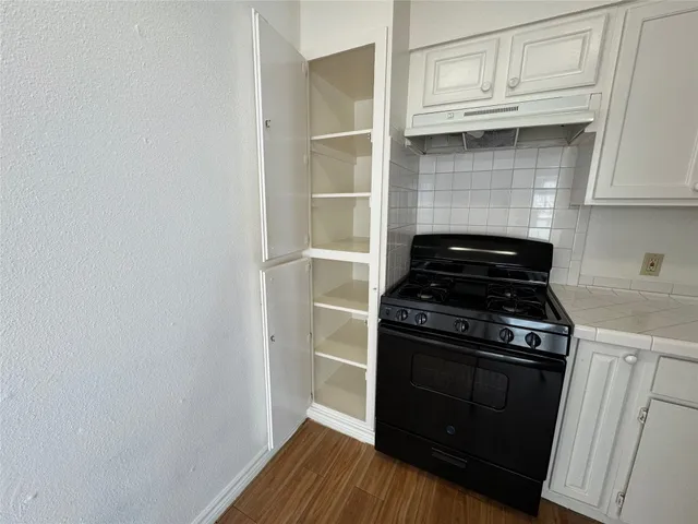 a kitchen with a stove and a cabinet