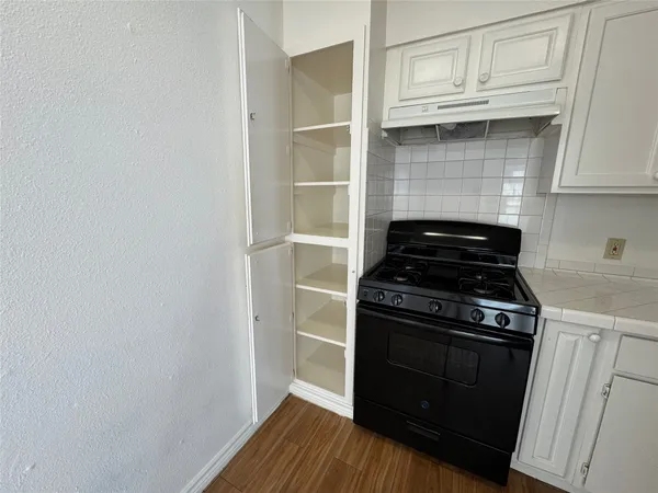 a kitchen with a stove and a cabinet