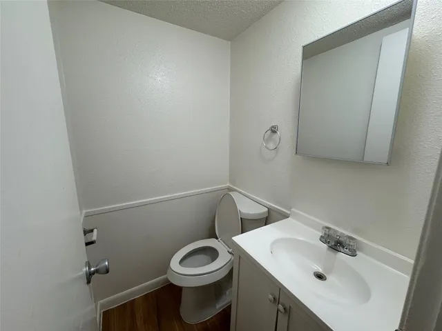 a bathroom with a sink a toilet and mirror
