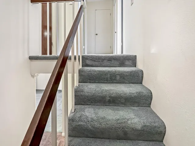 a view of staircase with wooden floor and stairs