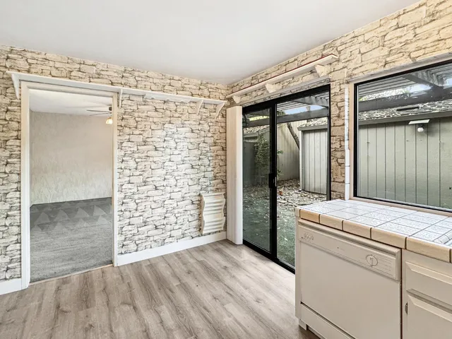 a view of a sink and bench in front of a door