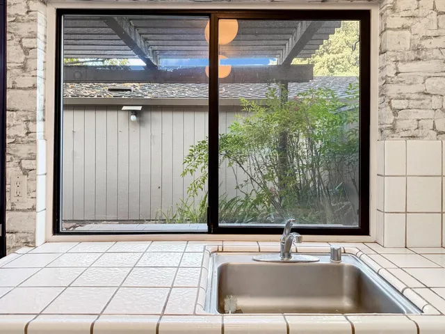 a bathroom with a granite countertop toilet