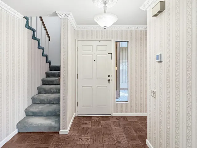 a view of entryway with stairs and white door
