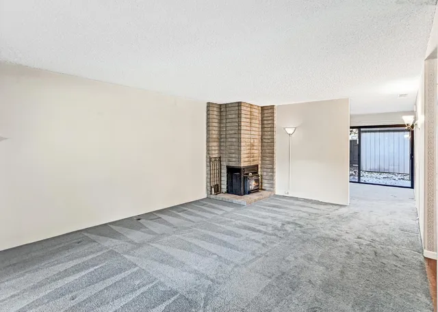 an empty room with furniture and a fireplace