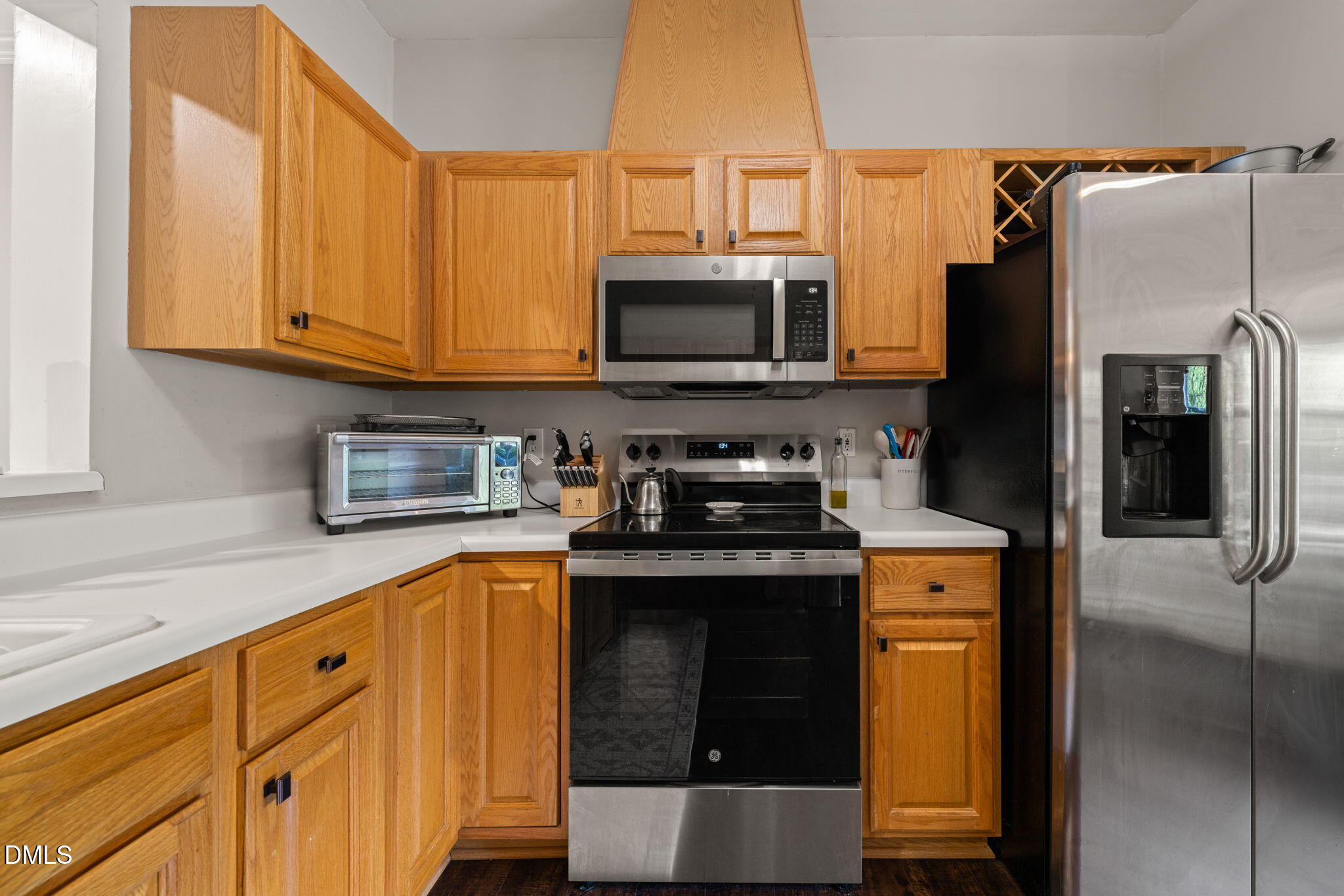 4323 Pine Springs Court Raleigh, NC 27613 - Photo 6 of 38 a kitchen with stainless steel appliances granite countertop a refrigerator a stove top oven a sink and dishwasher