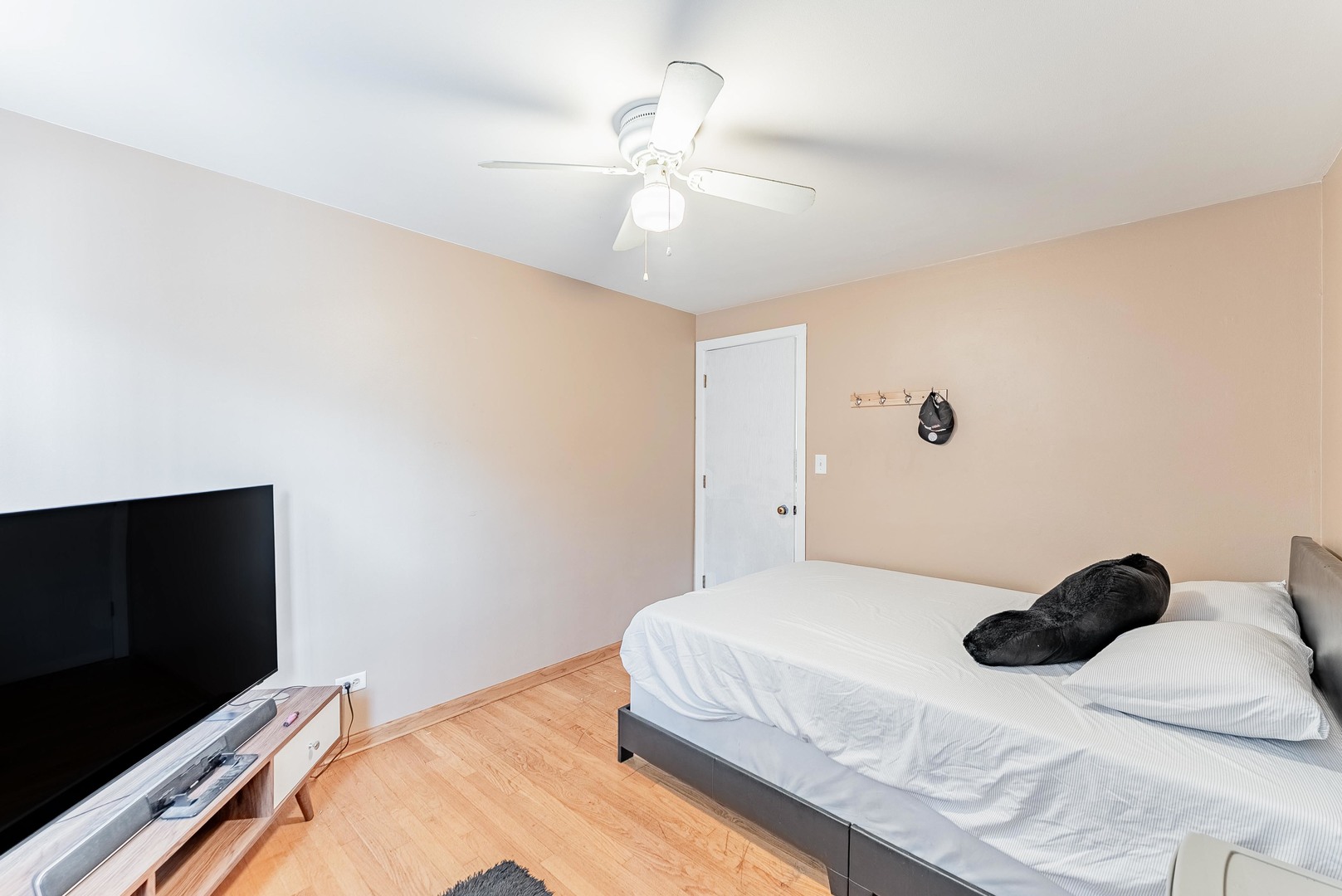 6031 South Normandy Avenue Chicago, IL 60638 - Photo 14 of 26 a bedroom with a bed and a flat tv screen on dresser