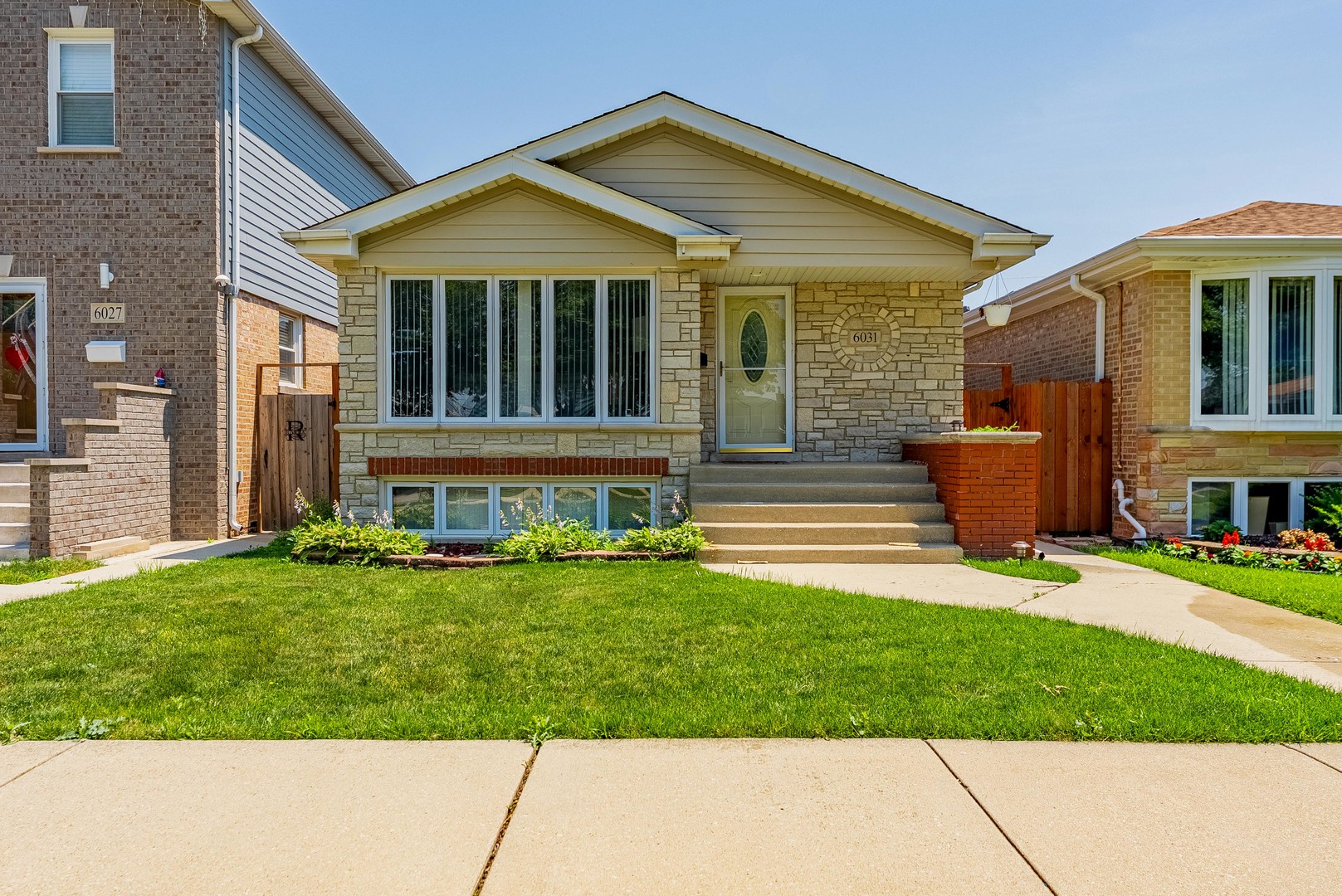 6031 South Normandy Avenue Chicago, IL 60638 - Photo 2 of 26 a front view of a house with a yard