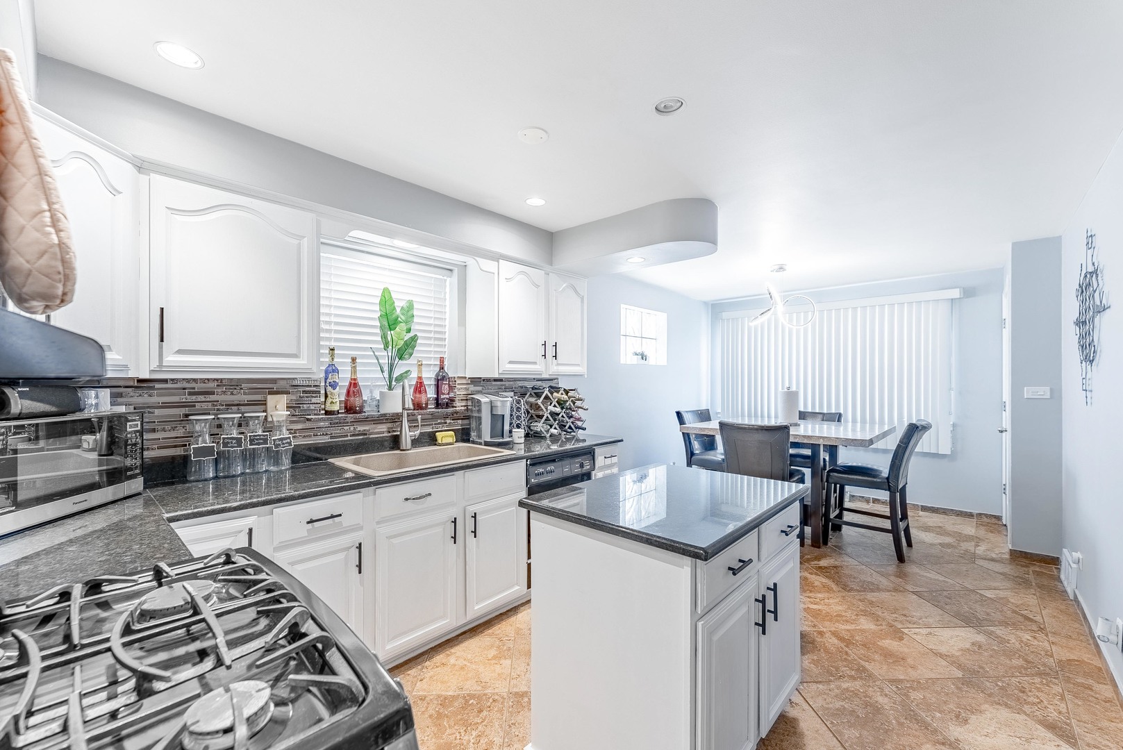 6031 South Normandy Avenue Chicago, IL 60638 - Photo 6 of 26 a kitchen with a stove a sink and a refrigerator