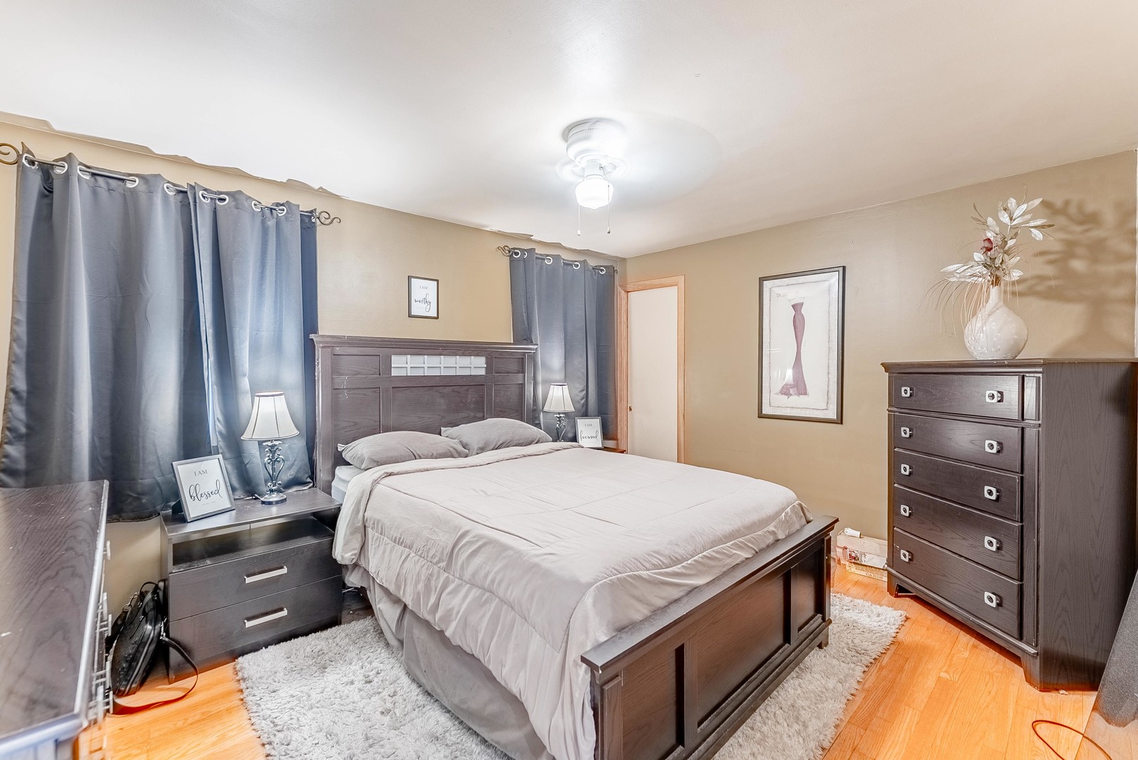 6031 South Normandy Avenue Chicago, IL 60638 - Photo 9 of 26 a bedroom with a bed and a dresser