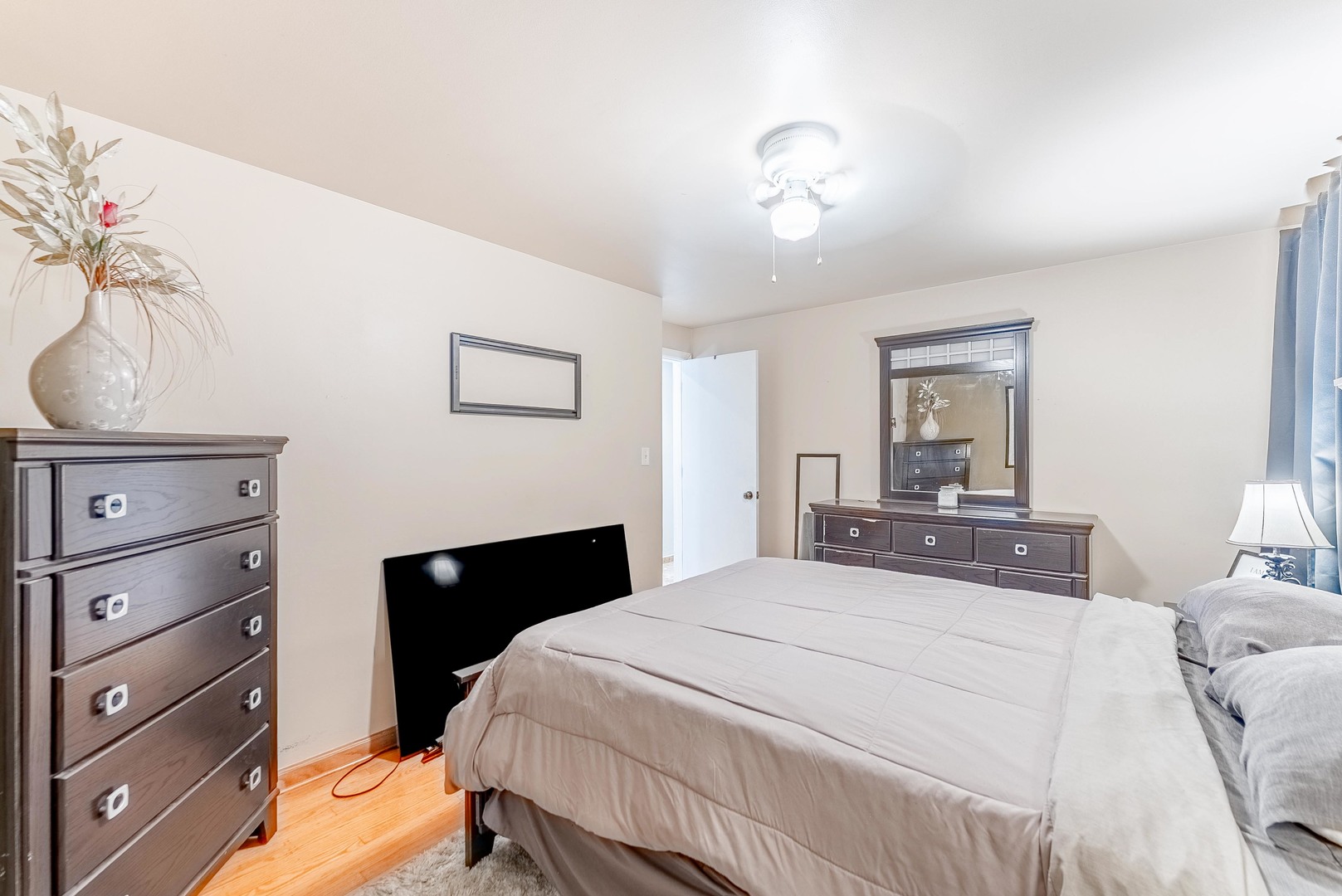 6031 South Normandy Avenue Chicago, IL 60638 - Photo 10 of 26 a bedroom with a bed and a chandelier