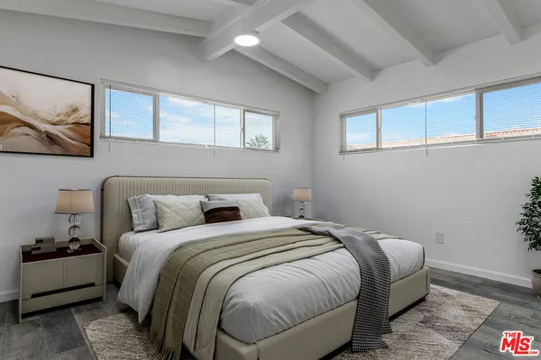 a bedroom with a bed and wall painting