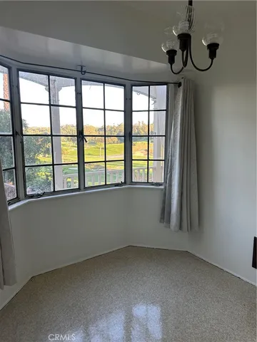 a view of an empty room with windows