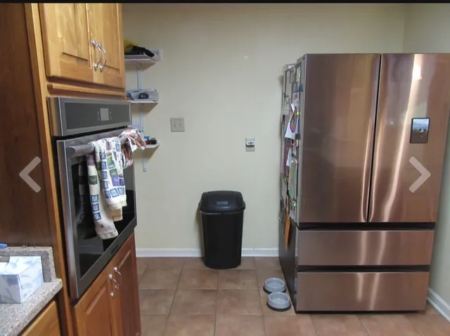 a living room with furniture and kitchen