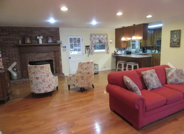 a living room with furniture and kitchen view