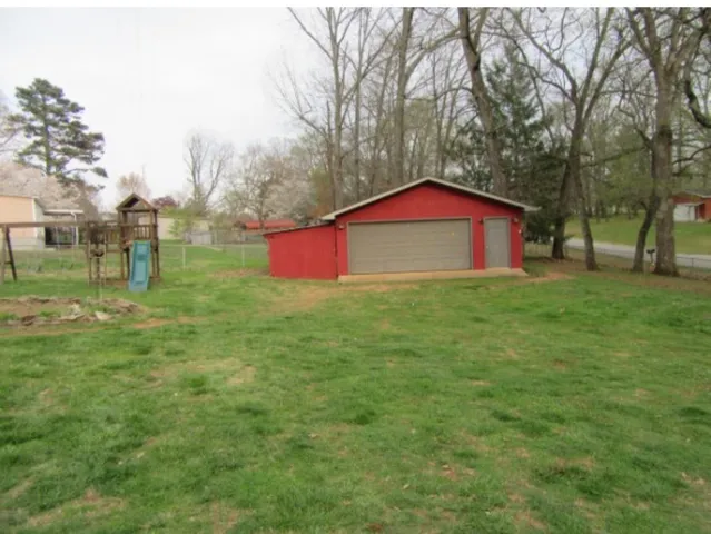 a big house with a big yard and large trees