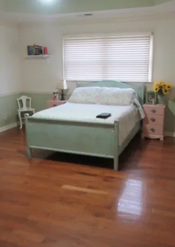 a bedroom with a bed and window