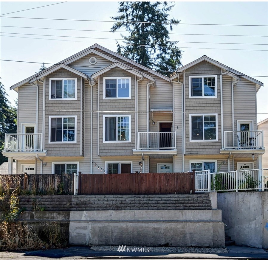 1311 North 145th Street, Unit B Seattle, WA 98133 - Photo 1 of 31 a front view of a house with a yard