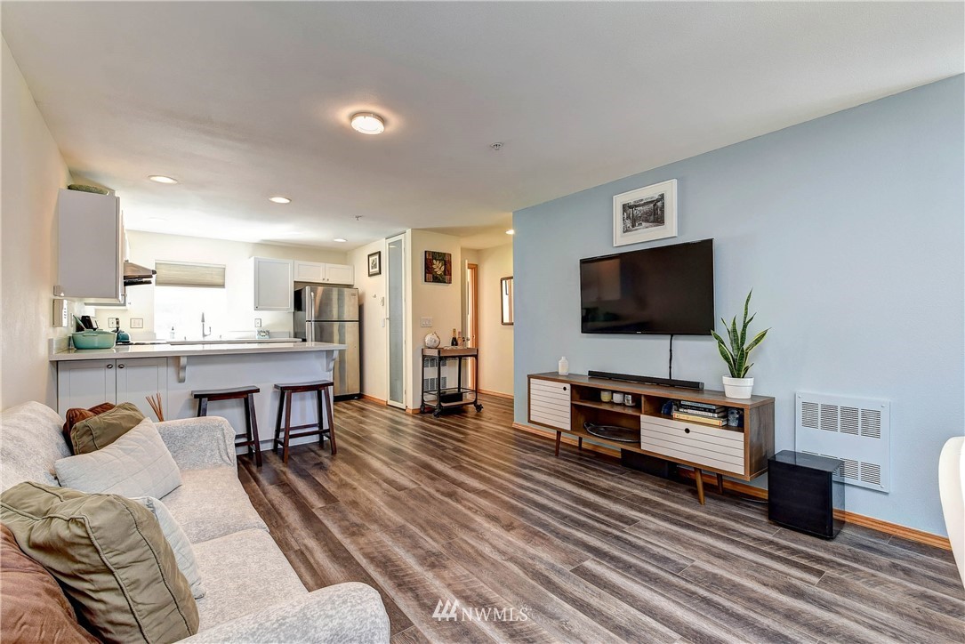 1311 North 145th Street, Unit B Seattle, WA 98133 - Photo 12 of 31 a living room with furniture and a flat screen tv