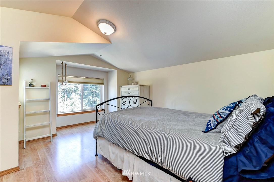 1311 North 145th Street, Unit B Seattle, WA 98133 - Photo 14 of 31 a bedroom with a bed and a window