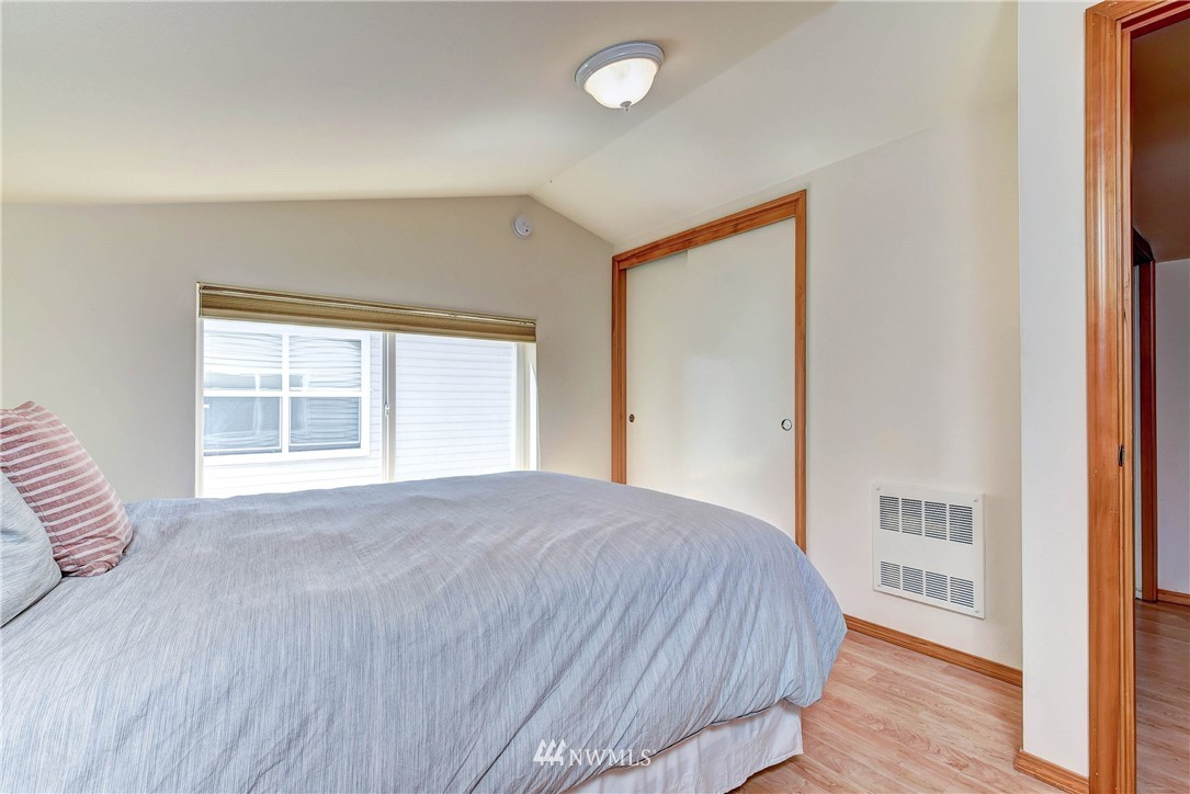 1311 North 145th Street, Unit B Seattle, WA 98133 - Photo 18 of 31 a bedroom with a bed and a window