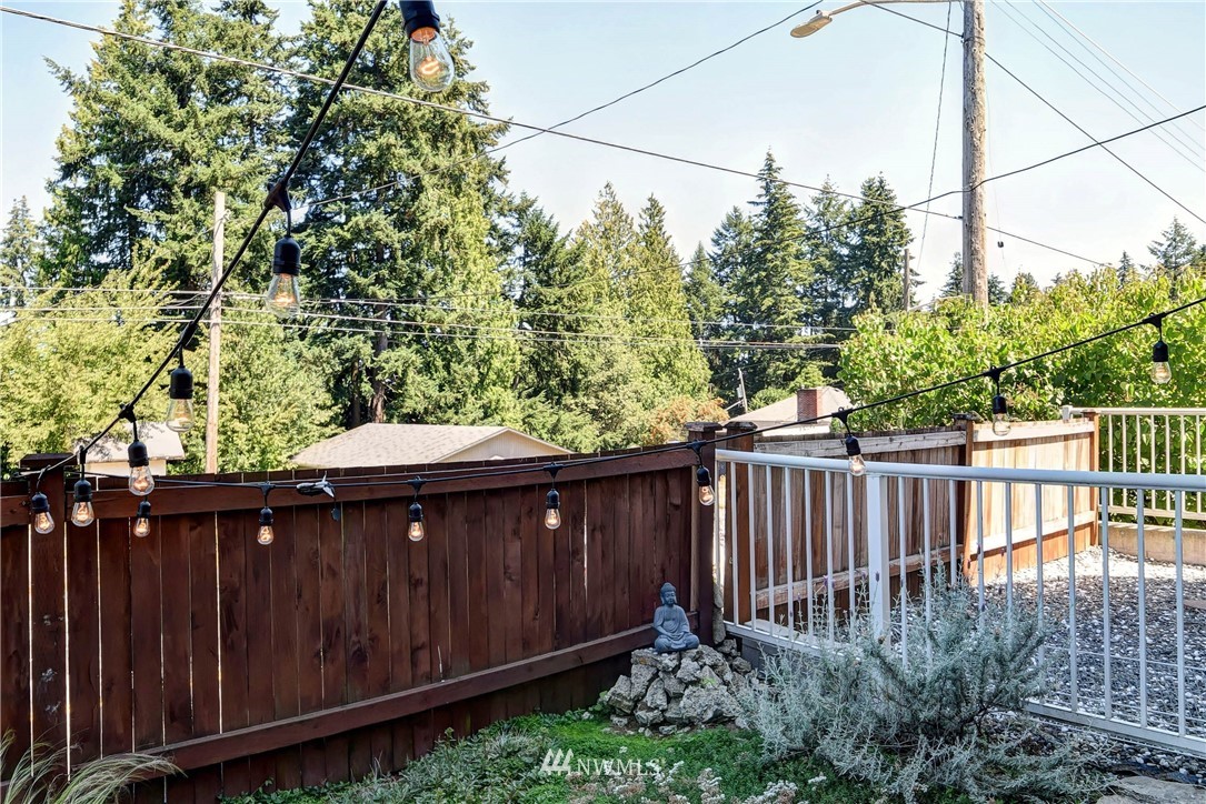 1311 North 145th Street, Unit B Seattle, WA 98133 - Photo 26 of 31 a view of a backyard with wooden fence