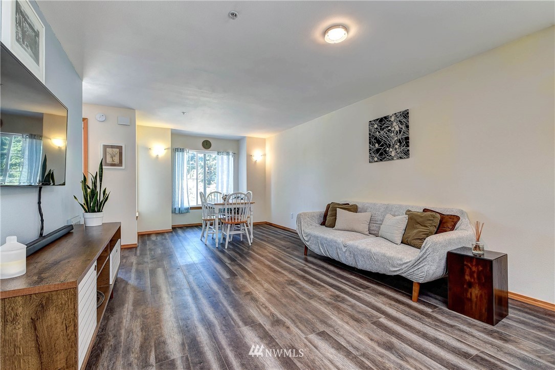 1311 North 145th Street, Unit B Seattle, WA 98133 - Photo 8 of 31 a living room with furniture and wooden floor