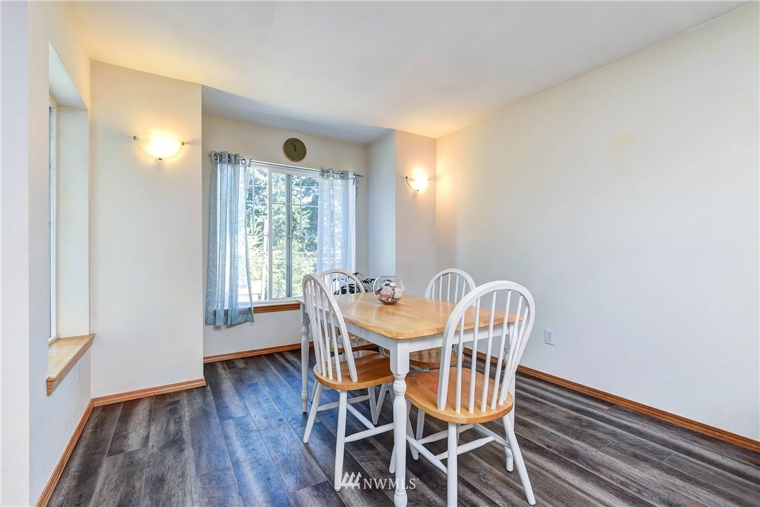 1311 North 145th Street, Unit B Seattle, WA 98133 - Photo 9 of 31 a view of a dining room with furniture window and wooden floor