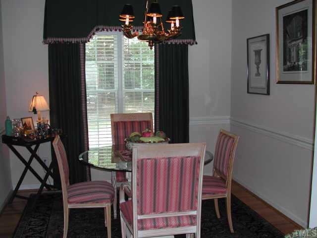 2505 Clerestory Place Raleigh, NC 27615 - Photo 4 of 10 a view of a dining room with furniture and chandelier
