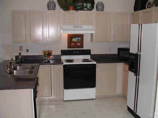 2505 Clerestory Place Raleigh, NC 27615 - Photo 5 of 10 a kitchen with a sink and a refrigerator