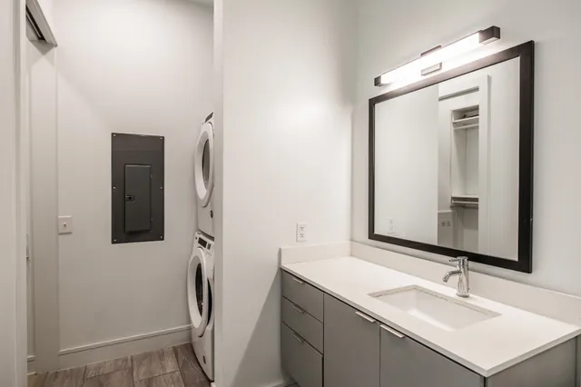 a bathroom with a sink vanity and mirror