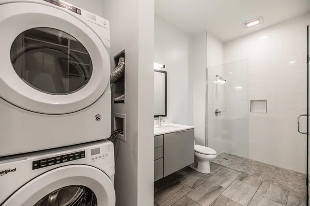 a view of a bathroom with washing machine and sink