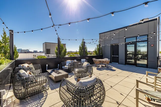 a living room with furniture a rug and a chandelier
